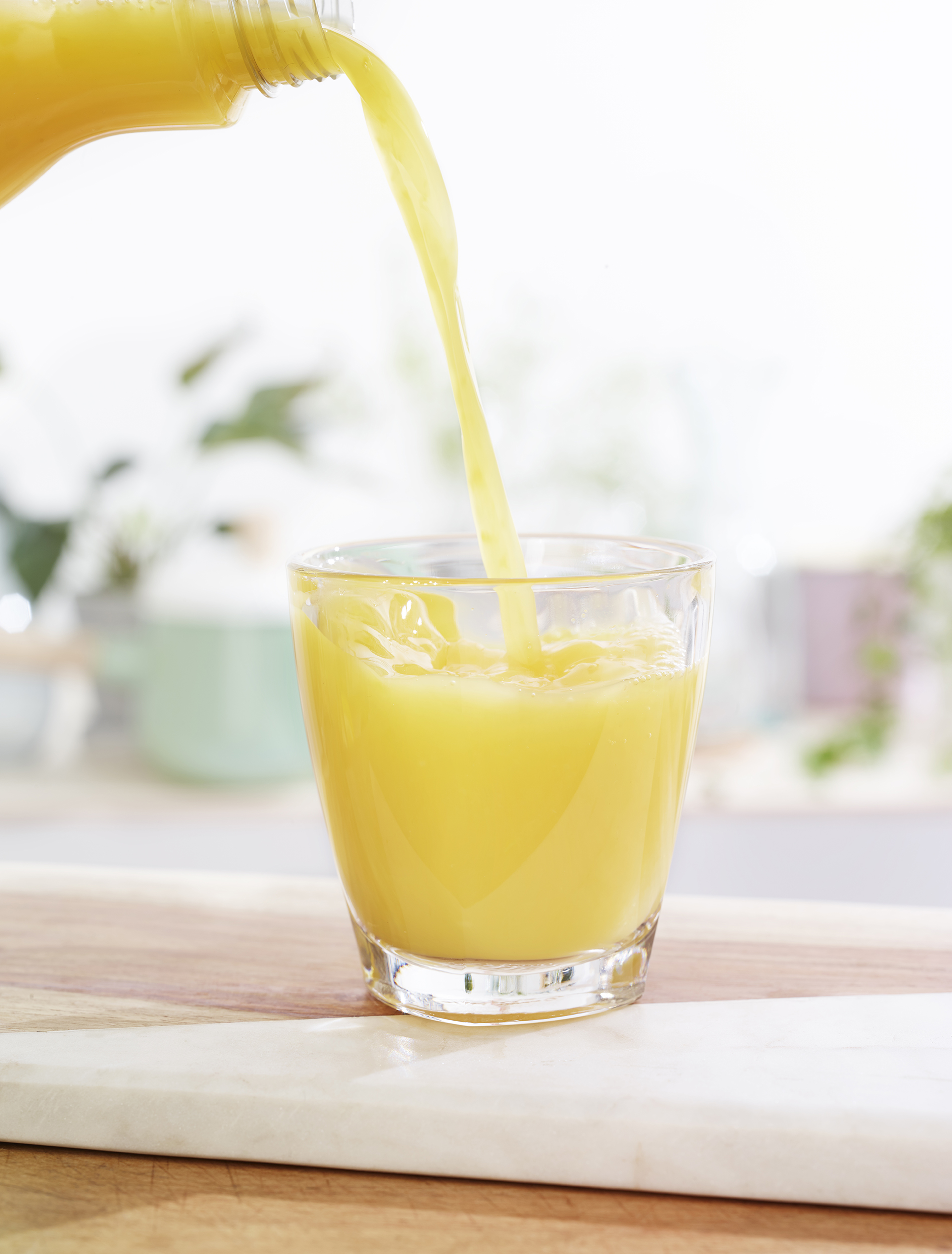Chelsea Bloxsome | Food Photographer London pouring orange juice